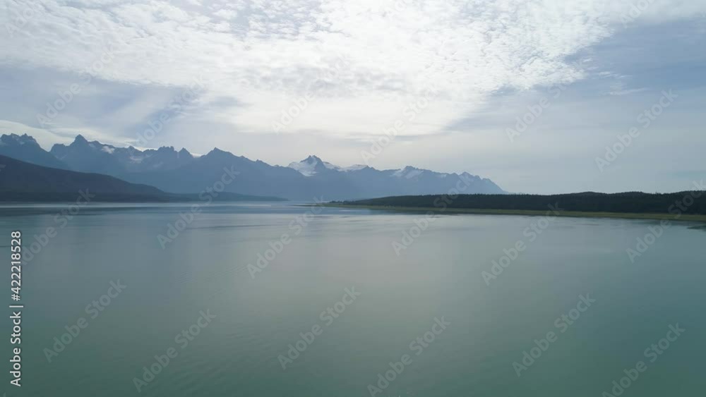 Aerial push in over Alaskan lake on sunny day Aerial push in over Alaskan lake on sunny day