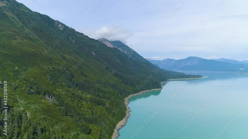 Aerial push in over Alaskan lake near mountain