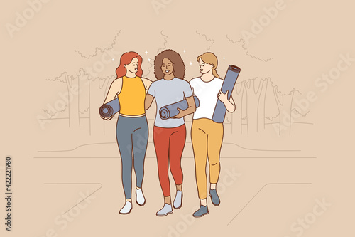 Practicing yoga, active healthy lifestyle concept. Three young smiling girls friends with yoga mats walking along street to lesson or practice feeling happy vector illustration 