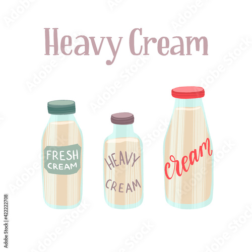 Fresh and tasty heavy cream in the different glass bottles. Healthy nutrition product.