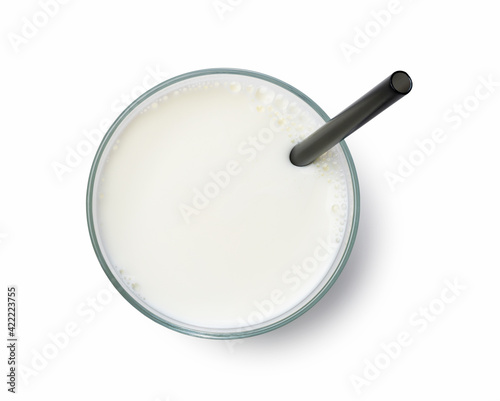 Milk in a glass and a straw on a white background.