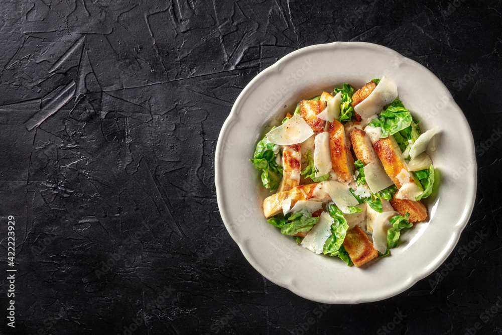 Caesar salad with chicken, overhead shot with a place for text Caesar salad with chicken, overhead shot with a place for text
