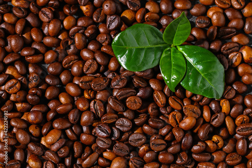 Roasted brown coffee beans. Top view. Coffee background texture.