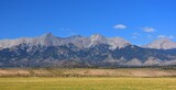 sand dunes and mountain peaks on a sunny day in great sand dunes national park,  near alamosa, colorado 