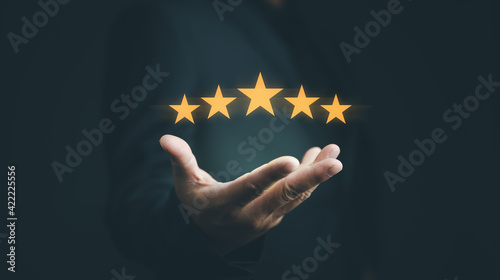 Customer evaluation feedback.men in suit Giving Positive Review for Client's Satisfaction Surveys.giving a five star rating. Service rating, satisfaction concept photo