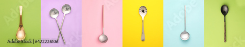 Different spoons on color background