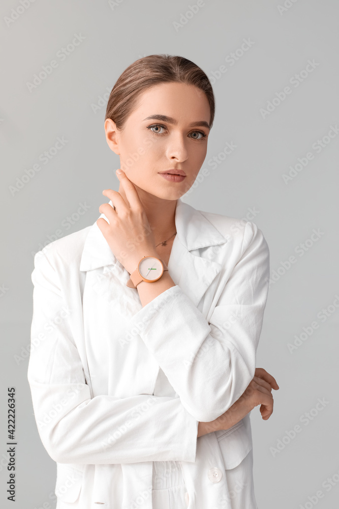 Woman with stylish wrist watch on light background Woman with stylish wrist watch on light background