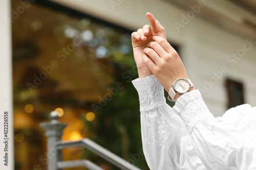 Woman with stylish wrist watch outdoors