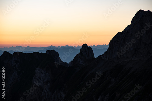 Misty sunset with beautiful silhouette of mountain range in Switzerland © RoMiEg