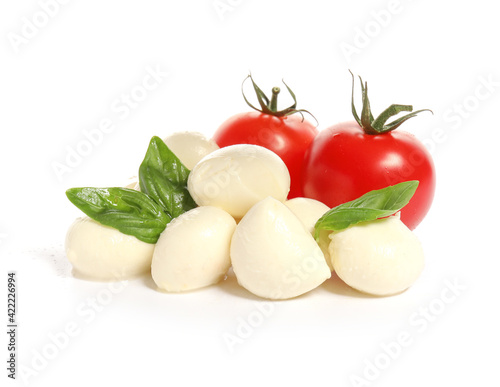 Mozzarella cheese with tomatoes and basil on white background