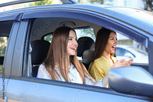 Happy young women sitting in car © Pixel-Shot