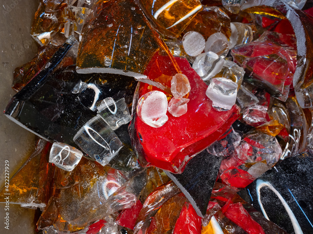 Stained glass shards and waste in a glass studio container Stained glass shards and waste in a glass studio container