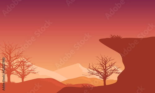 Nice panoramic view of mountains and dry trees at sunset from the suburbs. Vector illustration