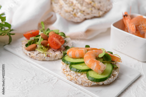 Tray with rice crackers on light background