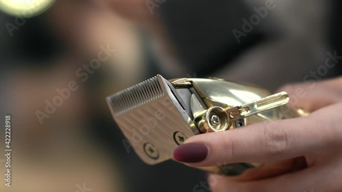 barber cleans the hair clipper