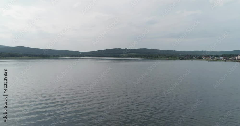 Mountain lake with smooth surface in Ural Mountains at summer cloudy day. Aerial drone above view. Mountain lake with smooth surface in Ural Mountains at summer cloudy day. Aerial drone above view.