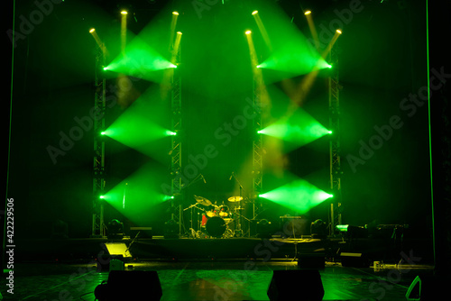 The light of searchlights in smoke on stage.
