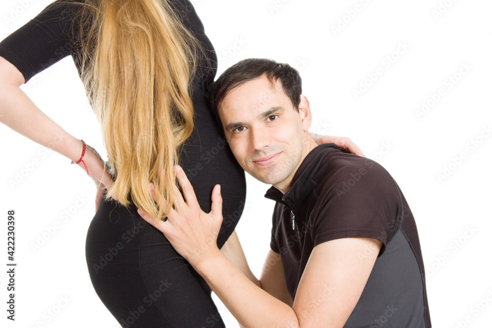 Obraz premium Photo of pregnant blonde and a man standing on a white isolated background