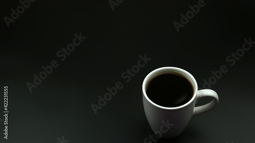 Close up black hot coffee white mug with black background.