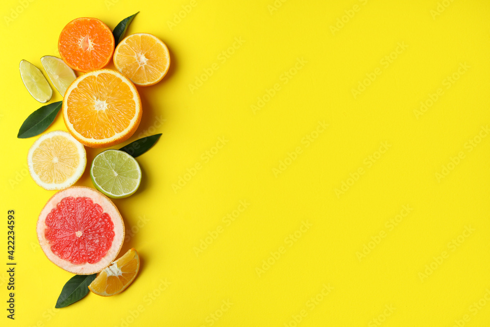 Ripe citrus on yellow background, space for text Ripe citrus on yellow background, space for text