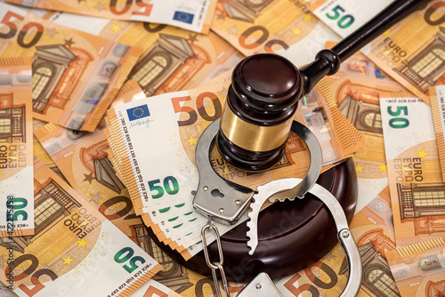 Handcuffs and euro banknotes