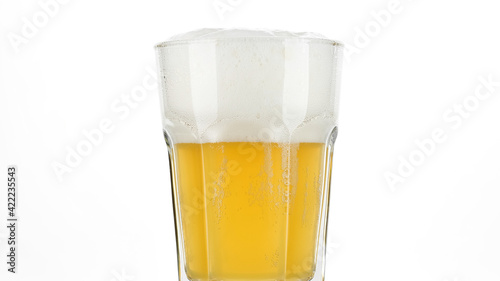glass of beer with foam on white background, close up