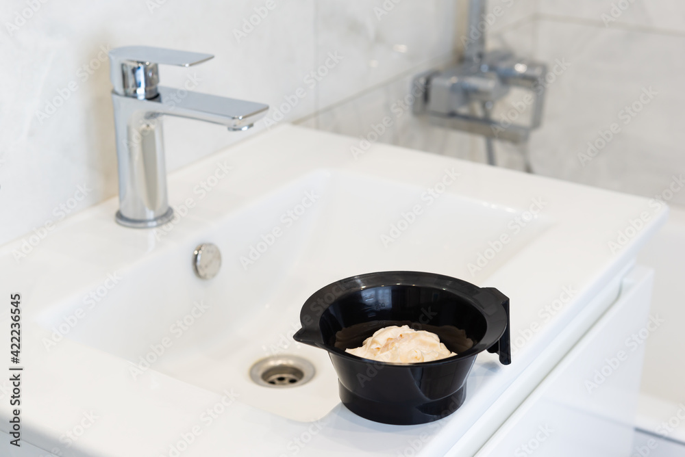 Hair dye on the bathroom sink. Self-coloring hair concept. Stock Photo ...