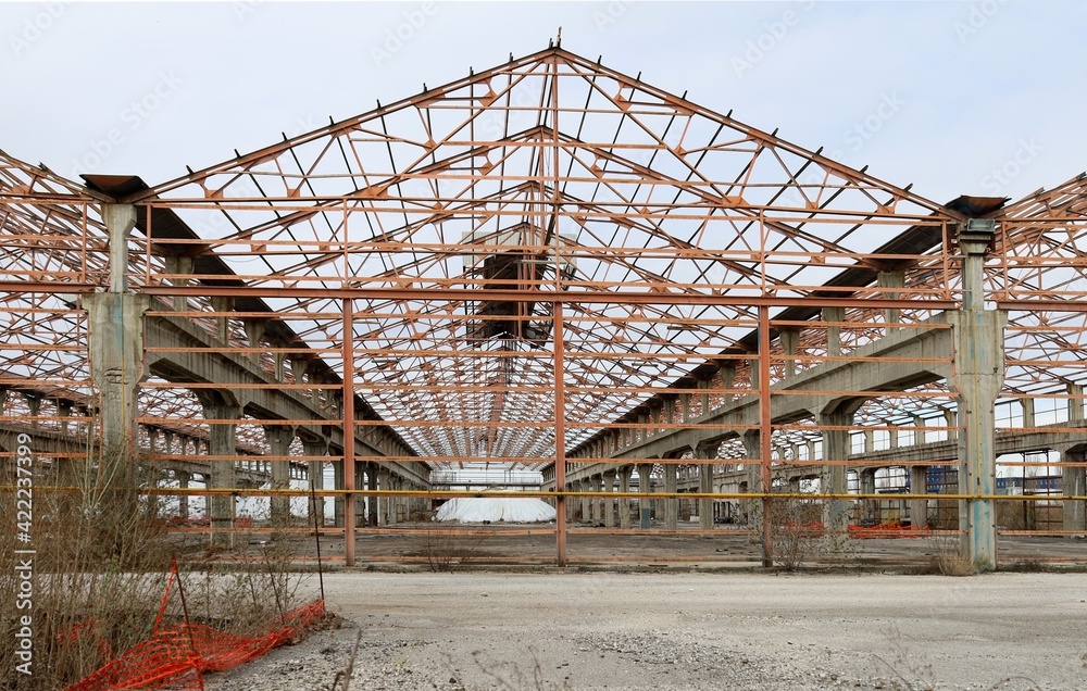 Metal structure of an old abandoned industrial warehouse to which the health dangerous asbestos cover has been removed