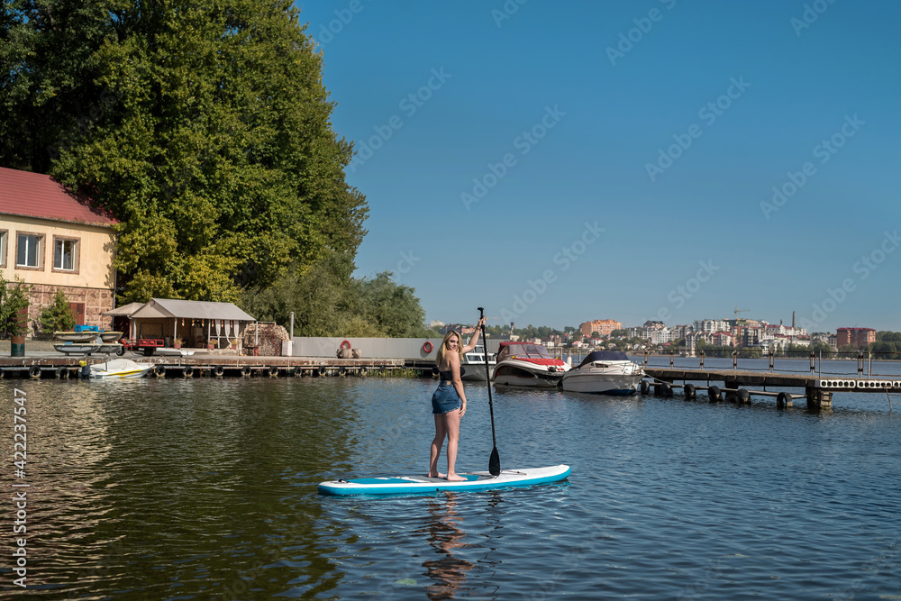 young pretty woman on SUP board enjoy summer lifestyle