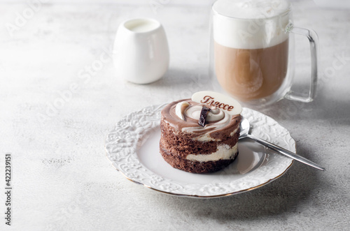 Chocolate cake and coffee lfor breakfast on light grey table photo