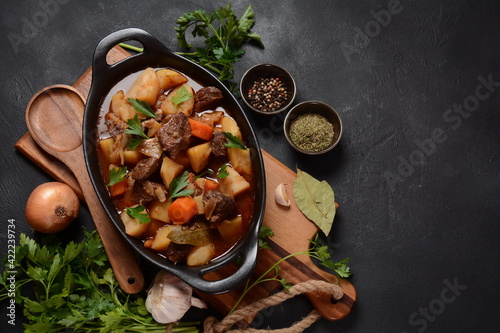 Irish stew made with beef, potatoes, carrots and herbs. Traditional St.Patrick's day dish, stewed in dark Guinness beer photo