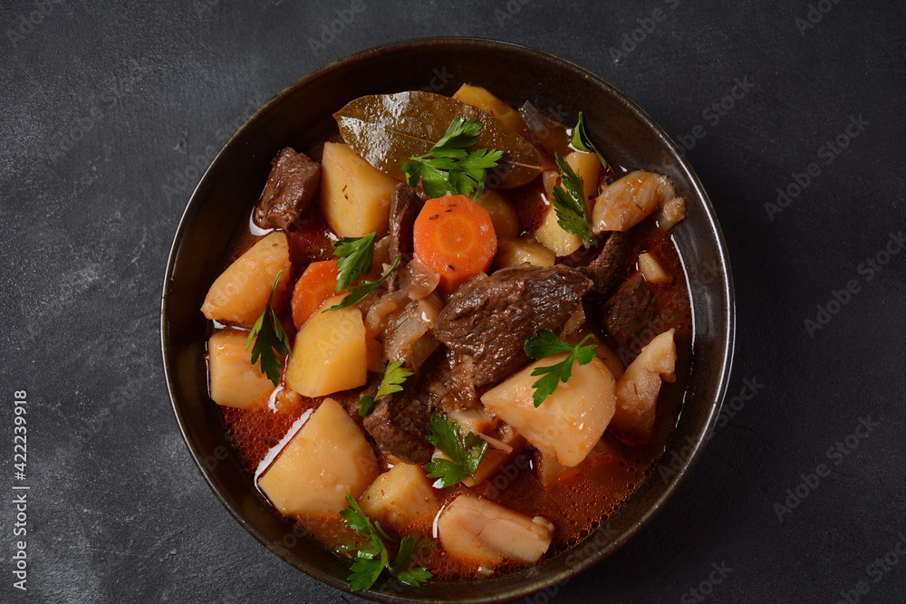 Irish stew made with beef, potatoes, carrots and herbs. Traditional St.Patrick's day dish, stewed in dark Guinness beer Irish stew made with beef, potatoes, carrots and herbs. Traditional St.Patrick's day dish, stewed in dark Guinness beer