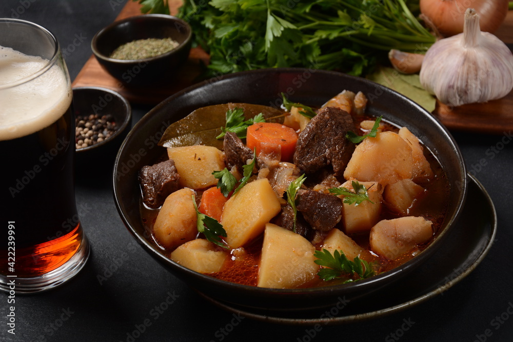 Irish stew made with beef, potatoes, carrots and herbs. Traditional St.Patrick's day dish, stewed in dark Guinness beer Irish stew made with beef, potatoes, carrots and herbs. Traditional St.Patrick's day dish, stewed in dark Guinness beer