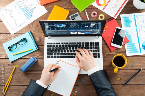 Close up businessman hands working at laptop