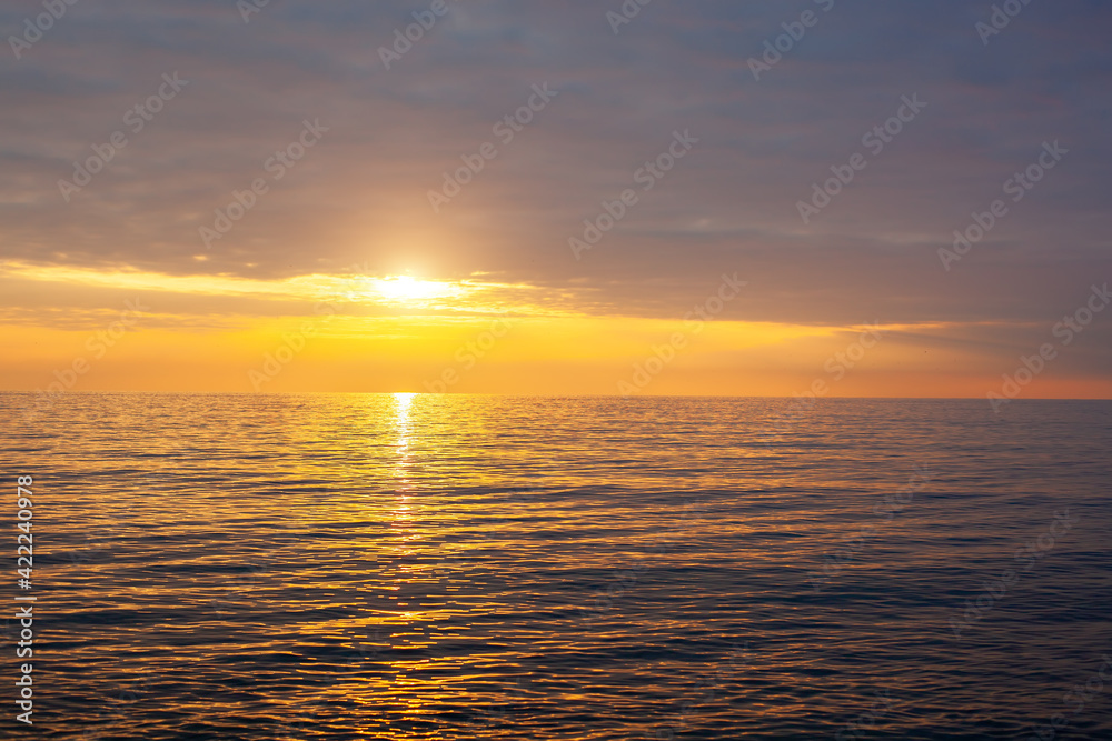 Amazing beach sunset with endless horizon. Horizontal. Selective focus.