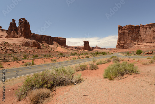 Scenic view of the road and red sandstone formations at Arches National Park in Utah on a sunny day