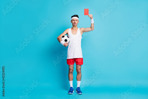 Fototapeta Naklejka Na Ścianę i Meble -  Full length photo of displeased person arm hold ball demonstrate red card isolated on blue color background