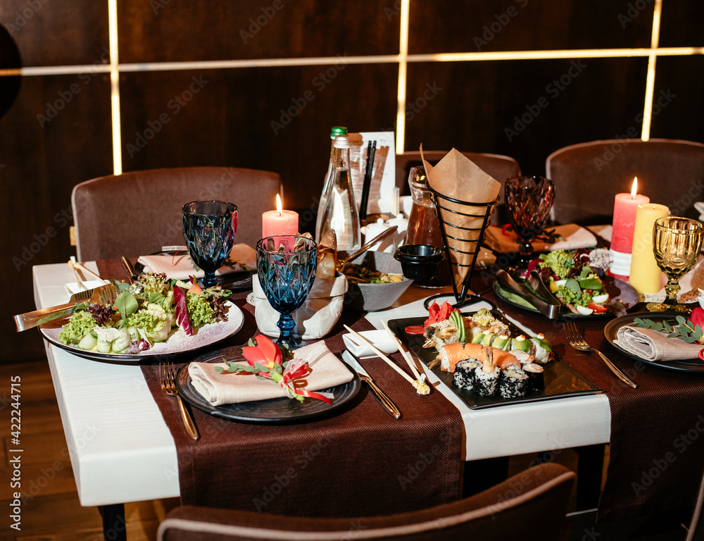 Sushi in a restaurant on a banquet table. Festive table setting with