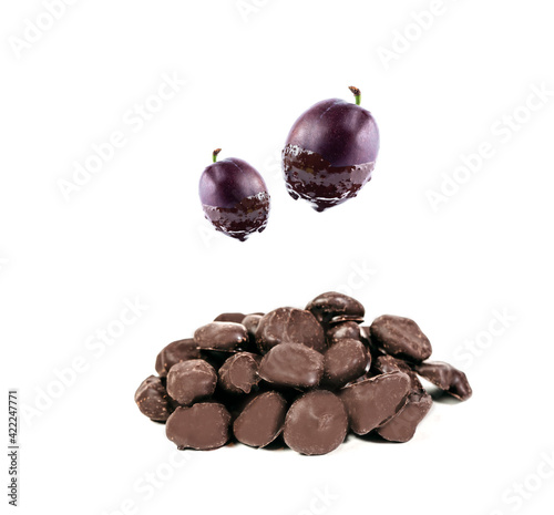 dried plum covered by milk chocolate, composition with  fresh fruits in chocolate isolated on white background. free space for text and logo.