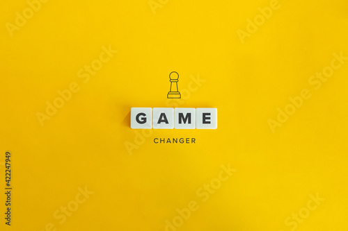 Game Changer Concept and Banner. Block Letters and Pawn Icon on Bright Orange Background. photo