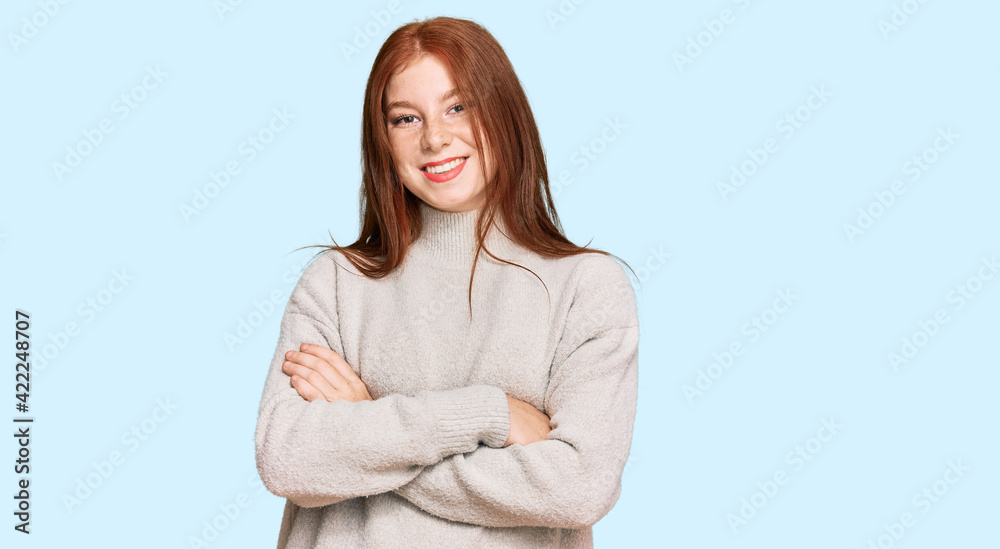 Young read head woman wearing casual winter sweater happy face smiling with crossed arms looking at the camera. positive person. Young read head woman wearing casual winter sweater happy face smiling with crossed arms looking at the camera. positive person.