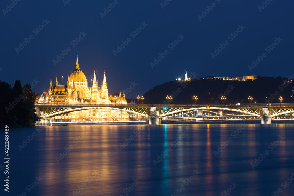 Parliament building over Margaret bridge in Budapest at night