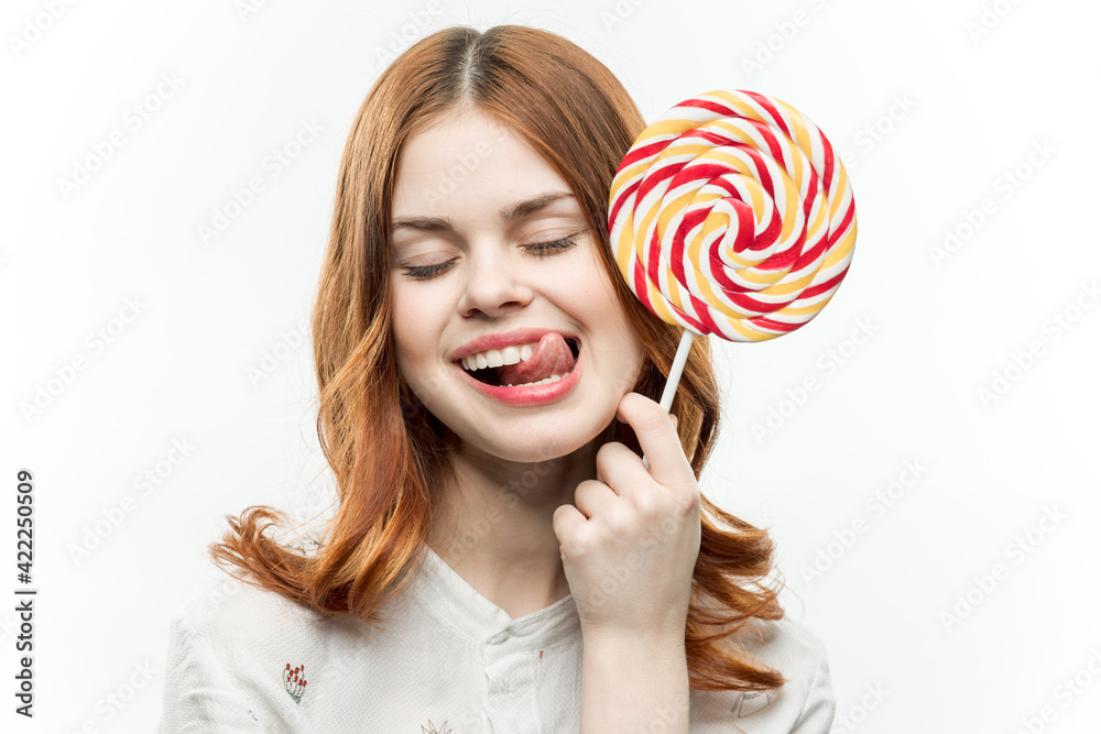 joyful woman with red hair lollipop sweets enjoyment