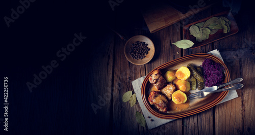 Rustic Snirtjebraten with red cabbage and cucumber photo