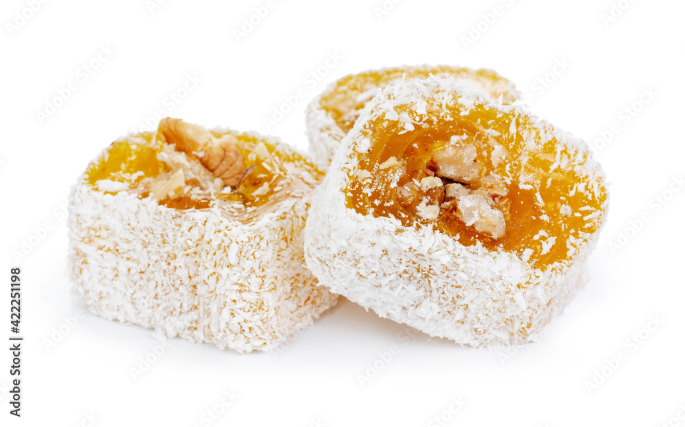 Yellow Turkish Delight with nuts in powdered sugar isolated on white Yellow Turkish Delight with nuts in powdered sugar isolated on white
