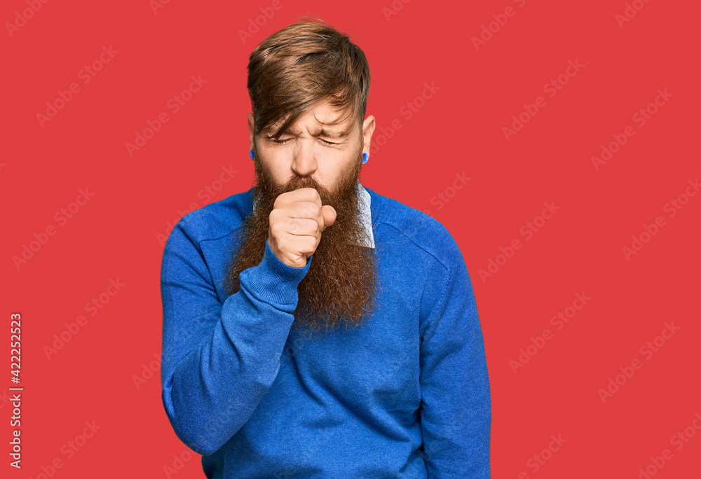 Young irish redhead man wearing casual clothes feeling unwell and coughing as symptom for cold or bronchitis. health care concept. Young irish redhead man wearing casual clothes feeling unwell and coughing as symptom for cold or bronchitis. health care concept.
