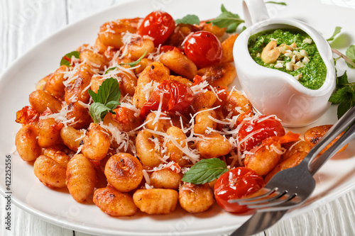 Potato gnocchi with tomatoes and pesto, top view