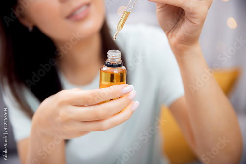 Woman hair care, drop of oil jojoba keratin restore and recovery damage after sun
