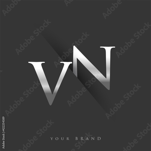 initial logo letter VN for company name, silver color and slash design in black background. vector logotype for business and company identity. photo