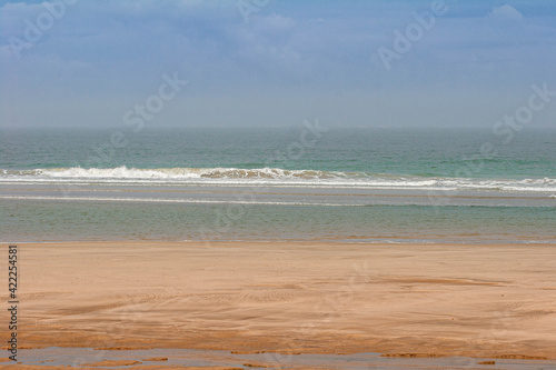 Beach at Soulac Sur Mer with a wave crashing photo